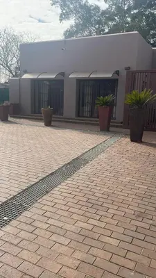 a building with potted plants in front of it at Pringle Studio in Benoni