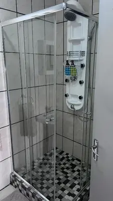 a shower with a glass door in a bathroom at Lumis Rest in Tzaneen
