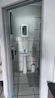 a bathroom with a sink and a toilet at Lumis Rest in Tzaneen
