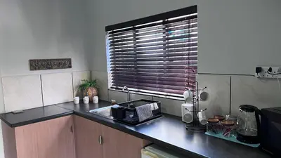 a kitchen with a sink and a window at Lumis Rest in Tzaneen