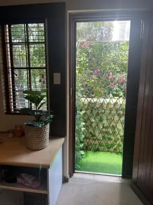 a room with a window with a plant next to it at Rose Loft in Centurion