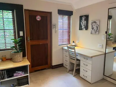 a home office with a desk and a door at Rose Loft in Centurion