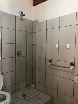 a bathroom with a shower stall with a toilet at Esibayeni Guesthouse in Nelspruit