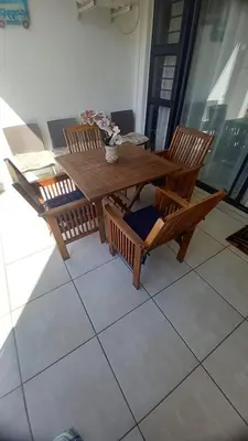 a wooden table and chairs sitting on a balcony at 521 at The Blyde in Pretoria