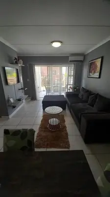 a living room with a couch and a table at 521 at The Blyde in Pretoria