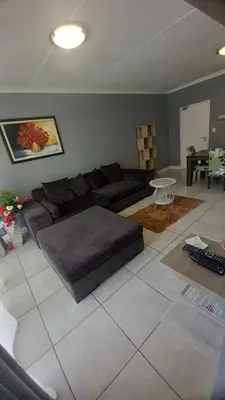 a living room with a couch and a table at 521 at The Blyde in Pretoria