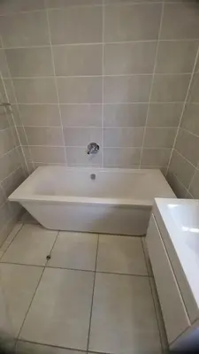 a white bath tub in a bathroom with a sink at 521 at The Blyde in Pretoria