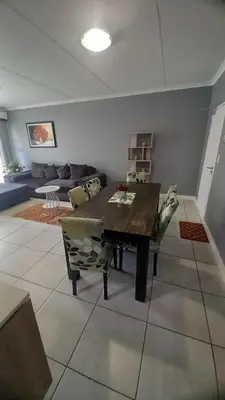 a living room with a table and a couch at 521 at The Blyde in Pretoria