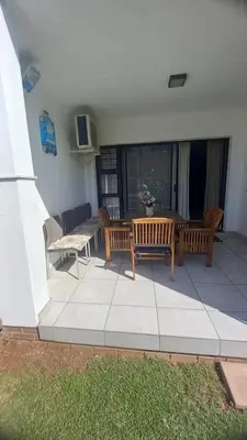 a patio with two benches and a table and chairs at 521 at The Blyde in Pretoria