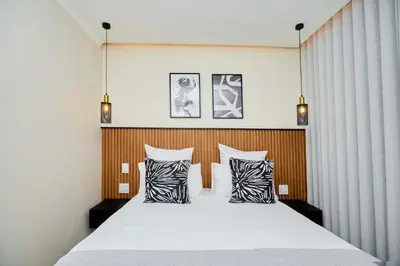a bedroom with a large bed with two pillows at The Dream, Unit N105 at Glen Park in Pretoria