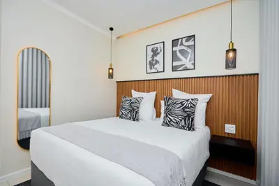 a bedroom with a large bed with two pillows at The Dream, Unit N105 at Glen Park in Pretoria