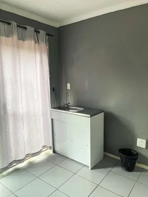 a bathroom with a sink and a shower curtain at Serenity in the city - one bedroom apartment in Pretoria