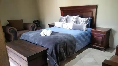 a bedroom with a bed with two towels on it at Jackal Buzzard Mountain Haven in Hillsowen