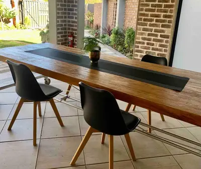 a wooden table with four chairs around it at Menlyn View Unit 8 in Pretoria