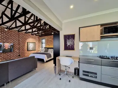 a living room with a kitchen and a bedroom at Menlyn View Unit 8 in Pretoria