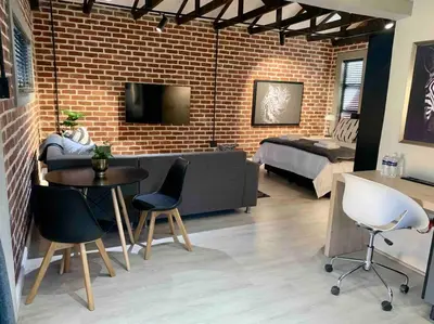 a living room with a bed and a table and chairs at Menlyn View Unit 8 in Pretoria