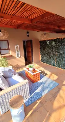 a patio with a couch and a coffee table at Stay at Fairway in Centurion