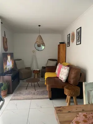a living room with a couch and a table at Mamuka Africa II in Midrand