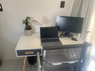 a desk with a laptop computer and a monitor at Mamuka Africa II in Midrand