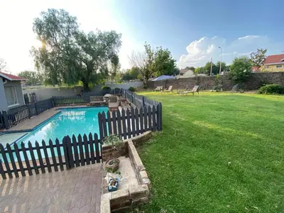 a fence around a swimming pool in a yard at Mamuka Africa II in Midrand