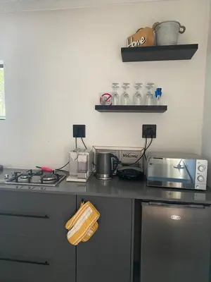 a kitchen with a counter top with a stove and appliances at Mamuka Africa II in Midrand