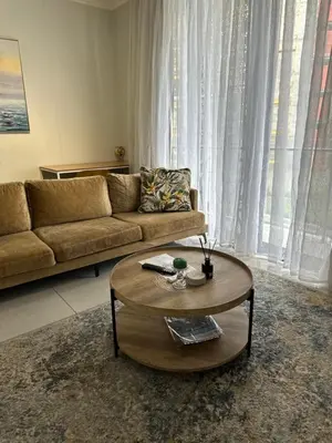 a living room with a couch and a coffee table at Luna luxury apartment in Midrand