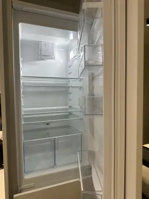 an empty refrigerator with its door open in a kitchen at Luna luxury apartment in Midrand