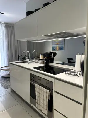 a kitchen with a sink and a stove top oven at Luna luxury apartment in Midrand