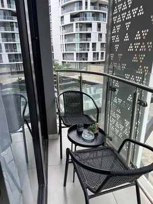 a balcony with two chairs and a table on it at Luna luxury apartment in Midrand