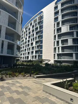 two tall buildings next to each other with a courtyard at Luna luxury apartment in Midrand