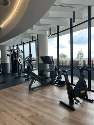 a gym with cardio machines and large windows at Luna luxury apartment in Midrand