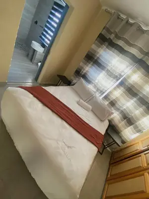 a large bed in a room with a window at Buffalo guest lodge in Bushbuckridge
