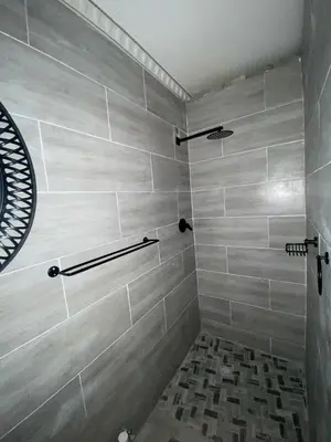 a bathroom with a shower with gray tiles at Buffalo guest lodge in Bushbuckridge