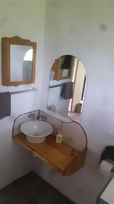 a bathroom with a sink and a mirror at Bushwhacked Barberton in Barberton