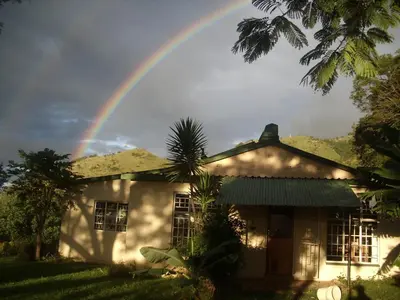 a rainbow over a house with at Bushwhacked Barberton in Barberton