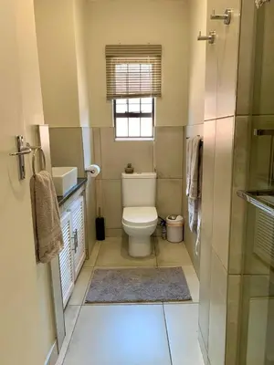 a small bathroom with a toilet and a window at Menlyn View Unit 6 in Pretoria
