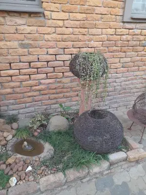 a water fountain in front of a brick wall at Yellowwood Accommodation in Polokwane