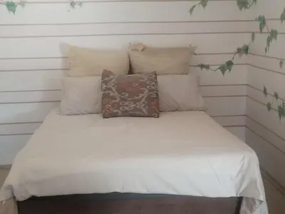 a bed with white sheets and pillows on it at 41onLeo in Eersbewoond