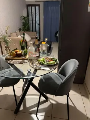 a glass table with a plate of food on it at Shayas Haven in Thohoyandou