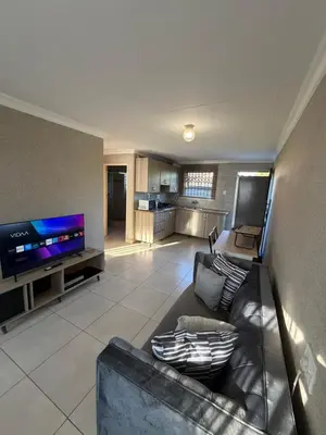 a living room with a couch and a flat screen tv at Shayas Haven in Thohoyandou