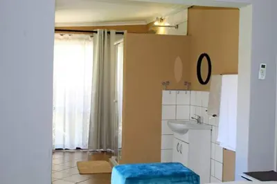 a bathroom with a sink and a toilet in it at Pool house 39 hoog in Polokwane