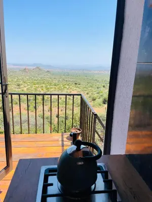 a tea pot sitting on a stove on a balcony at Makgobelo Lodge -The White House - Solar powered in Ga-Mokalapa