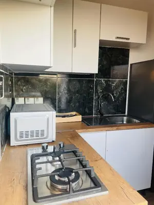 a kitchen with a stove top oven next to a microwave at Makgobelo Lodge -The White House - Solar powered in Ga-Mokalapa
