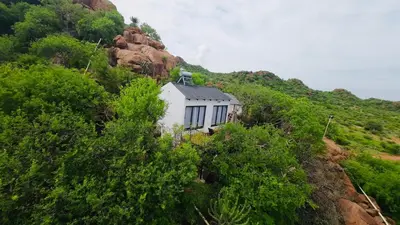 a white building on the side of a mountain at Makgobelo Lodge -The White House - Solar powered in Ga-Mokalapa