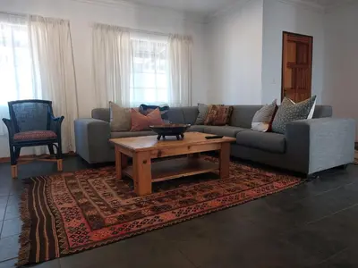 a living room with a couch and a coffee table at Graskop Cottage in Graskop