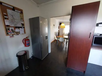 a kitchen with a refrigerator and a dining room at Graskop Cottage in Graskop