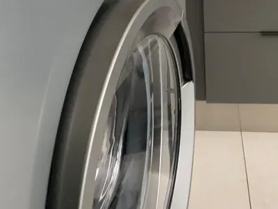 a close up of a washing machine in a kitchen at Umunlád Suites in Midrand