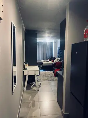 a living room with a table and a couch at Circa Lynwood flats,unit 223 Menlyn in Pretoria