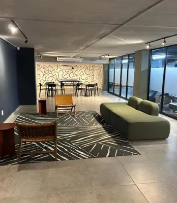 a large room with a couch and tables and chairs at Circa Lynwood flats,unit 223 Menlyn in Pretoria
