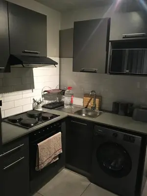 a kitchen with a stove and a washing machine at Circa Lynwood flats,unit 223 Menlyn in Pretoria